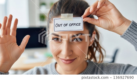 Woman smiling showing out of office status note 136927690