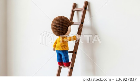 Amigurumi doll climbing ladder towards career success 136927837