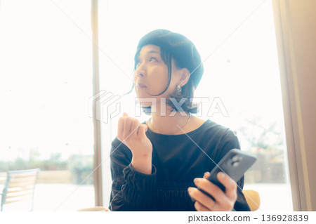 Adult woman enjoying sweets at a cafe Adult woman enjoying sweets at a cafe 136928839