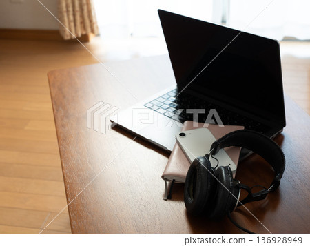 桌上放著電腦、筆記型電腦、智慧型手機和耳機。 桌上放著電腦、筆記型電腦、智慧型手機和耳機。 136928949