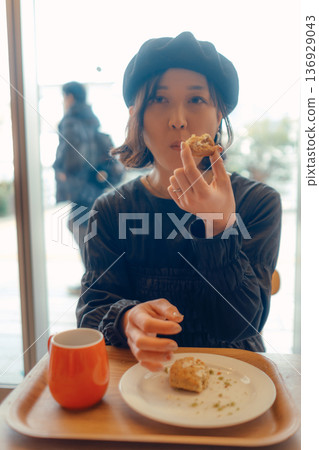 A woman in her 30s enjoying breakfast A woman in her 30s enjoying breakfast 136929043