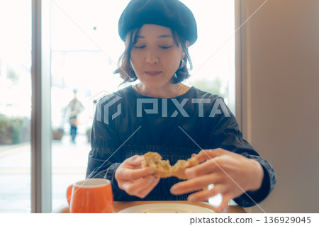 A woman in her 30s enjoying breakfast A woman in her 30s enjoying breakfast 136929045