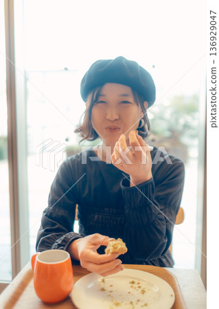 A woman in her 30s enjoying breakfast 136929047
