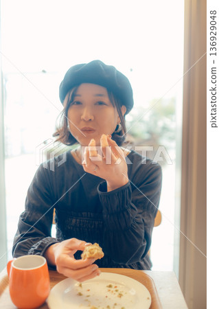 A woman in her 30s enjoying breakfast A woman in her 30s enjoying breakfast 136929048