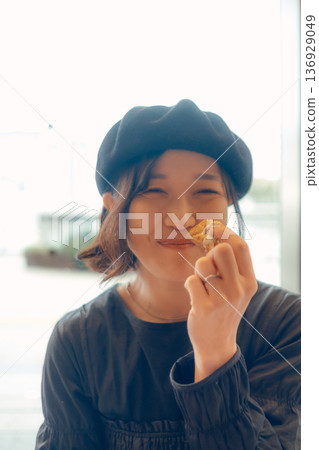 A woman in her 30s enjoying breakfast 136929049