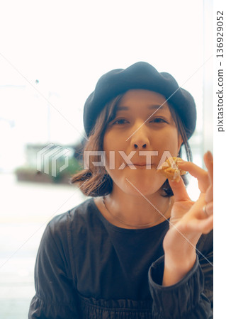 A woman in her 30s enjoying breakfast 136929052