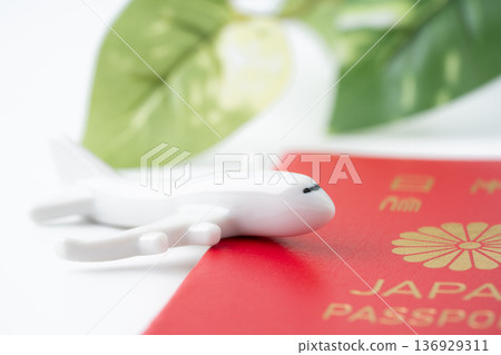 A red Japanese passport and a miniature airplane A red Japanese passport and a miniature airplane 136929311