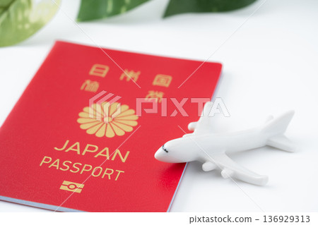 A red Japanese passport and a miniature airplane A red Japanese passport and a miniature airplane 136929313