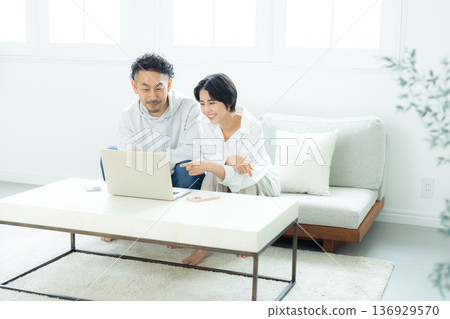 看一台個人計算機的中間夫婦在客廳 136929570