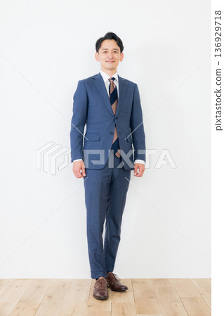 Smiling businessman standing 136929718