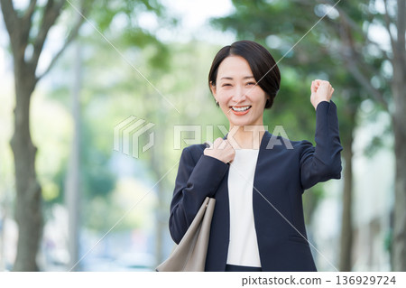 Commuting businessman and woman (fist pump) 136929724