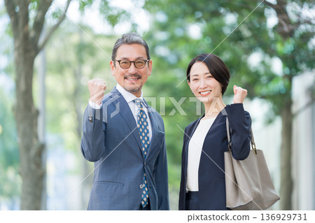 Smiling businessmen and women, fist pump 136929731