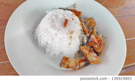 Authentic Thai crispy pork basil stir fry served with steamed rice, showcasing traditional local cuisine Authentic Thai crispy pork basil stir fry served with steamed rice, showcasing traditional local cuisine 136929803