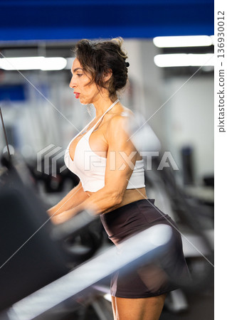 Fit woman training with intensity at gym Fit woman training with intensity at gym 136930012
