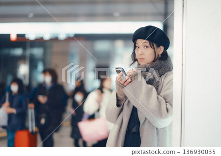 A woman in her 30s waiting indoors A woman in her 30s waiting indoors 136930035