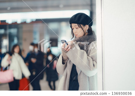 A woman in her 30s waiting indoors 136930036