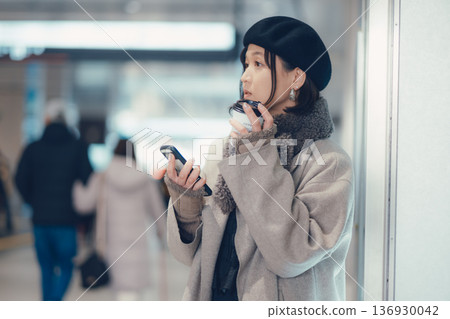 A woman in her 30s waiting indoors 136930042