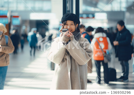 A woman in her 30s waiting indoors 136930296