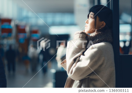 A woman in her 30s waiting indoors A woman in her 30s waiting indoors 136930311