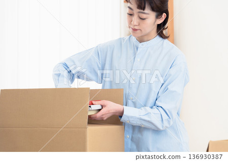 A girl organizing her books A girl organizing her books 136930387