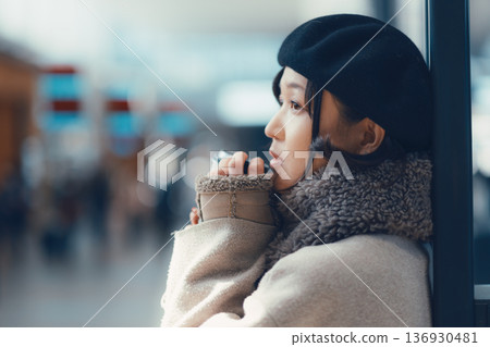 A woman in her 30s waiting indoors A woman in her 30s waiting indoors 136930481
