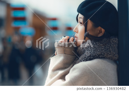 A woman in her 30s waiting indoors A woman in her 30s waiting indoors 136930482