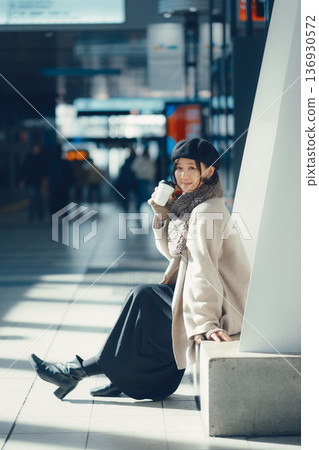 A woman waiting at a station in winter A woman waiting at a station in winter 136930572