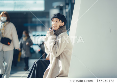 A woman waiting at a station in winter 136930578