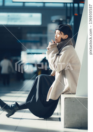 A woman waiting at a station in winter A woman waiting at a station in winter 136930587