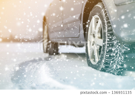 Close-up of car wheels rubber tires in deep winter snow. Transportation and safety concept. Close-up of car wheels rubber tires in deep winter snow. Transportation and safety concept. 136931135
