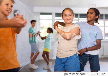 African boy and European girlie learn figures of pair jive dance and train before competition 136931184