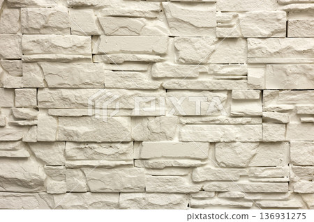 Close-up of white solid limestone wall or stone fence. Abstract copy space background, Bricklaying, construction and masonry concept. 136931275