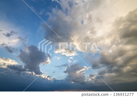 Blue sky covered with white puffy clouds. Blue sky covered with white puffy clouds. 136931277