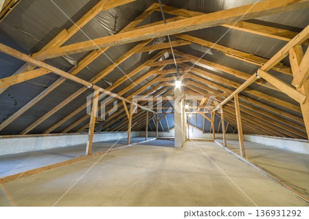 Attic of a building with wooden beams of a roof structure. Attic of a building with wooden beams of a roof structure. 136931292