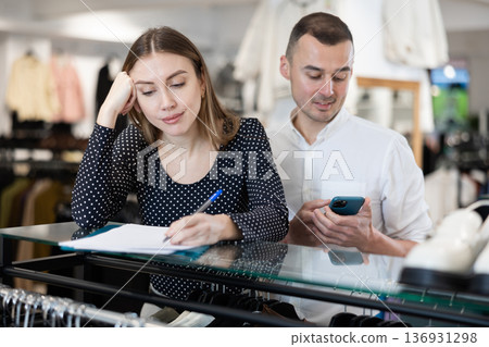 Couple woman and man with phone signing document Couple woman and man with phone signing document 136931298