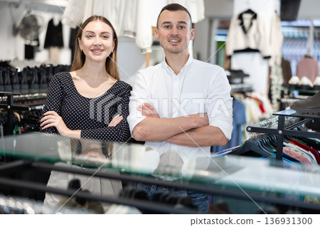 Married couple of businessmen stands in clothing store Married couple of businessmen stands in clothing store 136931300