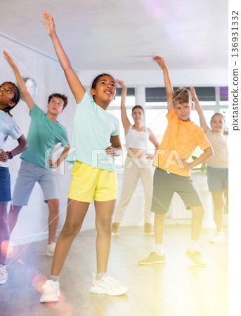 African girl perform social dance vogue with friends and female teacher in background African girl perform social dance vogue with friends and female teacher in background 136931332