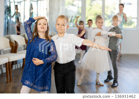 Children dance in pairs at festive matinee Children dance in pairs at festive matinee 136931462