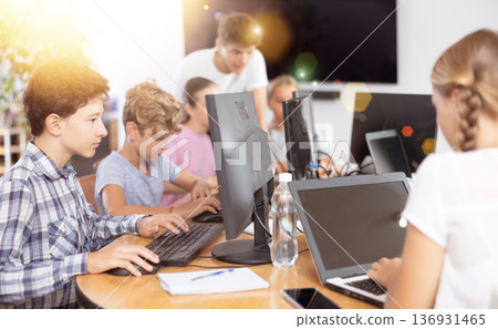 Boy student learning to work on computer in classroom 136931465