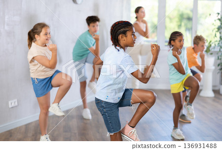 Cheerful african american tween boy training dynamic dance moves Cheerful african american tween boy training dynamic dance moves 136931488
