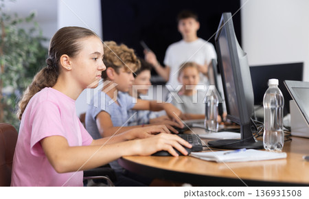 Girl student learning to work on computer in classroom 136931508