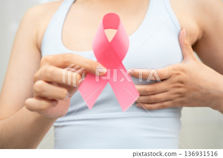 Breast cancer, pink ribbon at Asian senior lady for supporting awareness, symbol of World Breast Cancer Day. Breast cancer, pink ribbon at Asian senior lady for supporting awareness, symbol of World Breast Cancer Day. 136931516