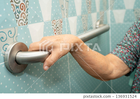 Asian elderly woman patient use toilet bathroom handle security in nursing hospital, healthy strong medical. 136931524
