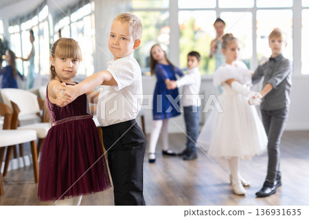 Preteen pupils rehearsing ballroom dance for festive school event Preteen pupils rehearsing ballroom dance for festive school event 136931635