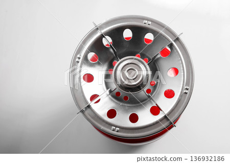 top view of a gas burner nozzle and the red body of the cylinder 136932186