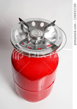 red camping cylinder with a burner and a folded metal handle red camping cylinder with a burner and a folded metal handle 136932189