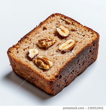 Delicious slice of homemade walnut cake on a clean white background, close-up view Delicious slice of homemade walnut cake on a clean white background, close-up view 136932842