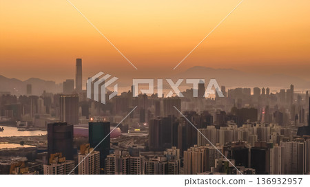 Jan 11 2026 Kowloon skyline glowing under warm golden sunset light Jan 11 2026 Kowloon skyline glowing under warm golden sunset light 136932957