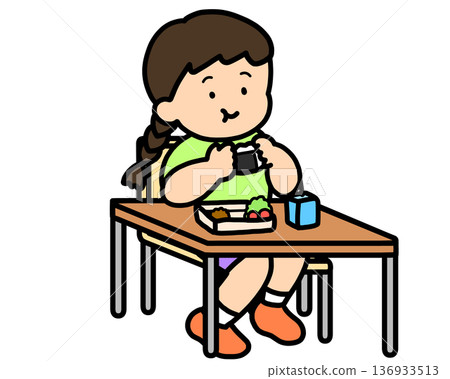 Lunchtime: Asian girl eating rice balls at her desk 136933513