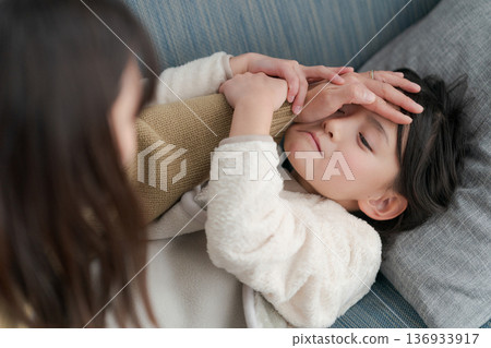 A sick girl and her mother caring for her A sick girl and her mother caring for her 136933917